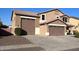 Two-story house with a large driveway and a three-car garage at 15936 W Canterbury Dr, Surprise, AZ 85379