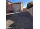 Attached garage and side yard with gravel at 15936 W Canterbury Dr, Surprise, AZ 85379