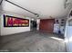 Spacious garage with ample storage and a car lift at 15936 W Canterbury Dr, Surprise, AZ 85379