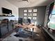 Home office with a large desk and car themed wall art at 15936 W Canterbury Dr, Surprise, AZ 85379