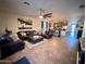 Open concept living room with kitchen view and tile floor at 15936 W Canterbury Dr, Surprise, AZ 85379