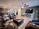 Spacious living room with leather furniture and a large TV at 15936 W Canterbury Dr, Surprise, AZ 85379