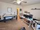 Home office with a large desk, comfortable chair, and plenty of natural light at 15936 W Canterbury Dr, Surprise, AZ 85379
