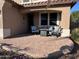 Covered patio with seating area and fire pit at 15936 W Canterbury Dr, Surprise, AZ 85379