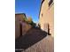Gravel side yard with gates and AC units at 15936 W Canterbury Dr, Surprise, AZ 85379