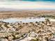 Aerial view of a single-story house near a lake and mountains at 17765 W Summit Dr, Goodyear, AZ 85338