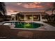 Backyard with a swimming pool, covered patio, and palm trees at 17765 W Summit Dr, Goodyear, AZ 85338