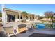 Inviting backyard with sparkling pool, fire pit, and patio at 17765 W Summit Dr, Goodyear, AZ 85338