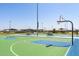 Outdoor basketball court with green and blue surface, surrounded by park amenities at 17765 W Summit Dr, Goodyear, AZ 85338