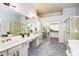 Double vanity bathroom with walk-in shower and separate tub at 17765 W Summit Dr, Goodyear, AZ 85338