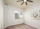 Spacious bedroom with large window and ceiling fan at 17765 W Summit Dr, Goodyear, AZ 85338