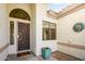 Front entrance with decorative door and sun/moon art at 17765 W Summit Dr, Goodyear, AZ 85338