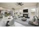 Gathering room includes a fireplace, comfortable seating, and adjacent kitchen at 17765 W Summit Dr, Goodyear, AZ 85338