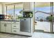 Kitchen with stainless steel dishwasher and backyard access at 17765 W Summit Dr, Goodyear, AZ 85338