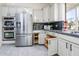 Stainless steel appliances and ample wooden cabinetry in this kitchen at 17765 W Summit Dr, Goodyear, AZ 85338
