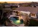 A backyard swimming pool, covered patio, desert landscaping at 17765 W Summit Dr, Goodyear, AZ 85338
