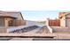 Pathway to lakefront with river rock landscaping and gated access at 17765 W Summit Dr, Goodyear, AZ 85338