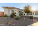 Single-story home with desert landscaping and a two-car garage at 18305 W Georgia Ave, Litchfield Park, AZ 85340