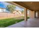 Covered patio extends to a grassy backyard, ideal for outdoor entertaining at 18526 E Swan Dr, Queen Creek, AZ 85142
