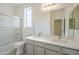 A bathroom with a double sink vanity, shower with glass doors, and large mirror for ample lighting at 18526 E Swan Dr, Queen Creek, AZ 85142