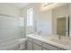 Bathroom featuring a double sink vanity, a shower with glass doors, and a large mirror at 18526 E Swan Dr, Queen Creek, AZ 85142