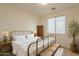 Charming bedroom with antique bed, decorative accents, and a plant at 18526 E Swan Dr, Queen Creek, AZ 85142