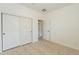 Bedroom with double door closet and access to hallway at 18526 E Swan Dr, Queen Creek, AZ 85142