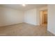 Spacious bedroom with wood-look floors and access to hallway at 18526 E Swan Dr, Queen Creek, AZ 85142