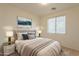 Cozy bedroom with a queen-size bed, neutral tones, and a window with blinds at 18526 E Swan Dr, Queen Creek, AZ 85142