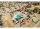 Community pool with surrounding lounge chairs and playground at 18526 E Swan Dr, Queen Creek, AZ 85142