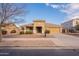 Single-story house with tan exterior, landscaped yard, and driveway at 18526 E Swan Dr, Queen Creek, AZ 85142