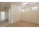 Bright hallway with wood-look floors and doors to bedrooms at 18526 E Swan Dr, Queen Creek, AZ 85142