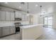Spacious kitchen featuring stainless steel appliances, an island, and sleek countertops at 18526 E Swan Dr, Queen Creek, AZ 85142