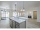 A bright open-concept kitchen featuring an island with a sink and breakfast bar at 18526 E Swan Dr, Queen Creek, AZ 85142