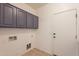 Functional laundry room with upper cabinets and space for washer/dryer at 18526 E Swan Dr, Queen Creek, AZ 85142