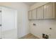 Convenient laundry area with overhead cabinets and utility connections at 18526 E Swan Dr, Queen Creek, AZ 85142