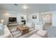 Bright living room featuring comfortable seating, a fireplace, and a large TV at 18526 E Swan Dr, Queen Creek, AZ 85142