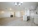 A spacious living room featuring a fireplace adjacent to an open concept kitchen with island at 18526 E Swan Dr, Queen Creek, AZ 85142
