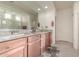 Double vanity bathroom with granite countertops and a large mirror at 21778 N 259Th Ln, Buckeye, AZ 85396