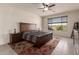 Main bedroom with a large bed, ceiling fan, and plenty of natural light at 21778 N 259Th Ln, Buckeye, AZ 85396