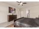 Main bedroom with a large bed, dresser, and ceiling fan at 21778 N 259Th Ln, Buckeye, AZ 85396