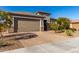 Single-story home with a two-car garage and desert landscaping at 21778 N 259Th Ln, Buckeye, AZ 85396