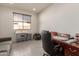 Bright home office features a large desk and comfortable seating at 21778 N 259Th Ln, Buckeye, AZ 85396
