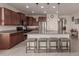 Spacious kitchen boasting granite countertops and a large island with seating at 21778 N 259Th Ln, Buckeye, AZ 85396