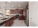 Eat-in kitchen with stainless steel appliances and granite countertops at 21778 N 259Th Ln, Buckeye, AZ 85396