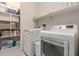 Laundry room with washer, dryer, and built-in shelving at 21778 N 259Th Ln, Buckeye, AZ 85396
