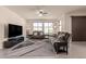 Relaxing living room with plush sofas, a large TV, and ample natural light at 21778 N 259Th Ln, Buckeye, AZ 85396