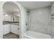 Elegant bathroom with a soaking tub and gray tile at 2227 E Catalina Dr, Phoenix, AZ 85016