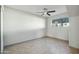 Bedroom with ceiling fan, window, and tile floors at 2227 E Catalina Dr, Phoenix, AZ 85016
