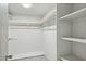 Large walk-in closet with shelves and hanging rods at 2227 E Catalina Dr, Phoenix, AZ 85016